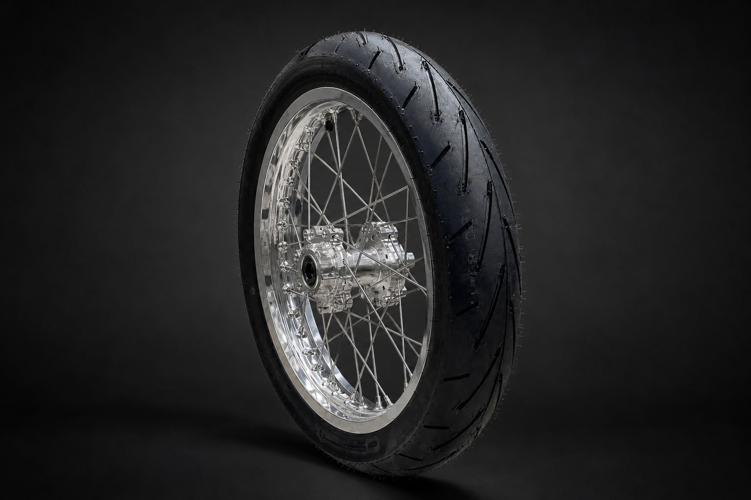 Chrome e-moto wheel viewed at a 45 degree angle with the complete hub visible